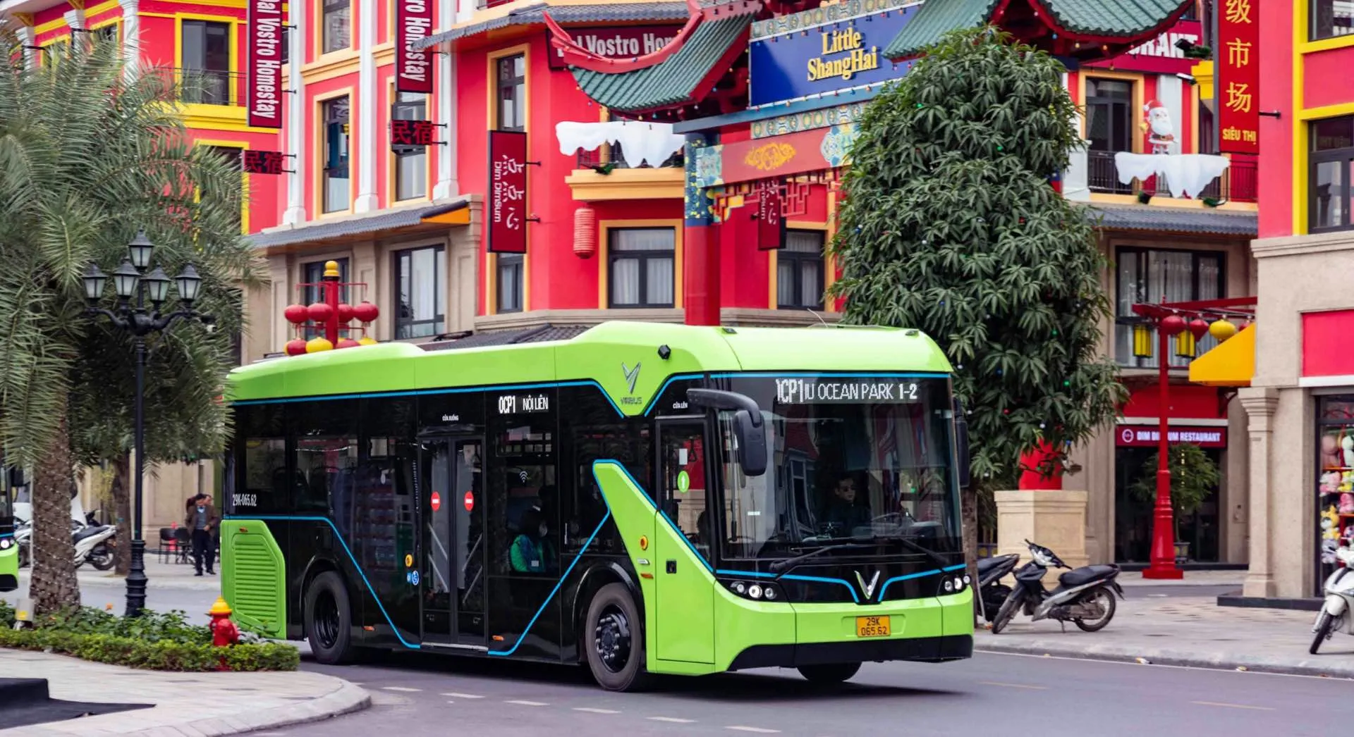 A bright green electric city bus on a street
